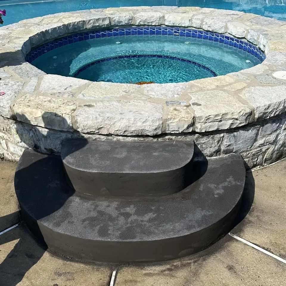 Stone and concrete spa surround with curved steps