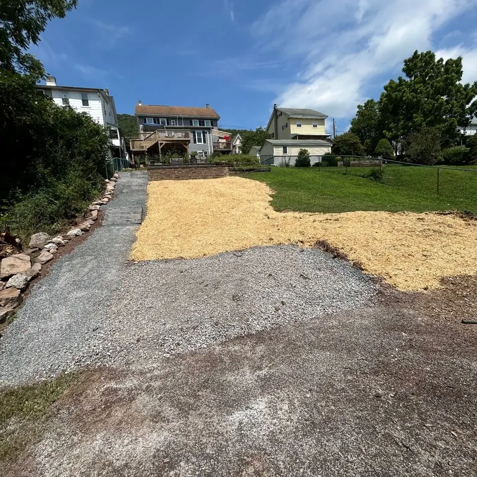 Backyard grading and gravel base ahead of a new hardscape