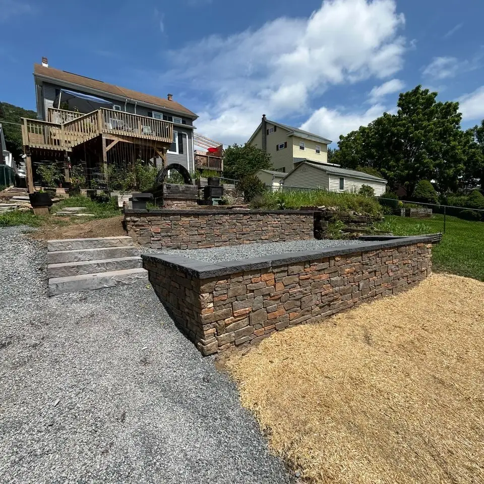 Stone retaining wall and steps on a sloped backyard