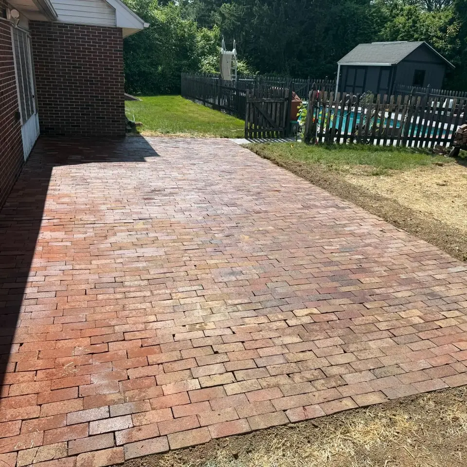 Newly laid brick paver patio beside a house